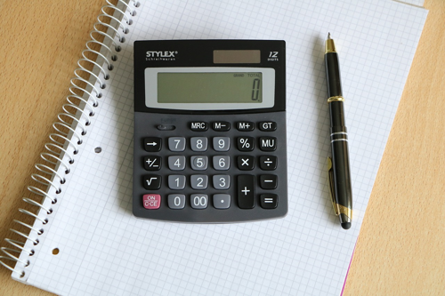 Calculator with a pen and pad