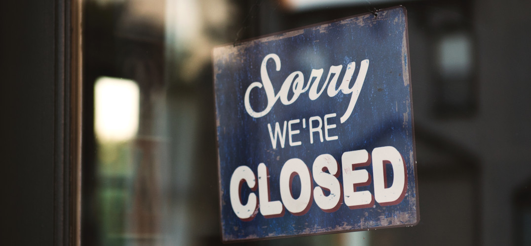 Sorry we're closed sign in a shop window