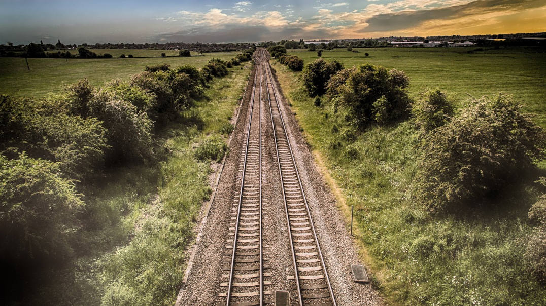 Empty train track running through countryside