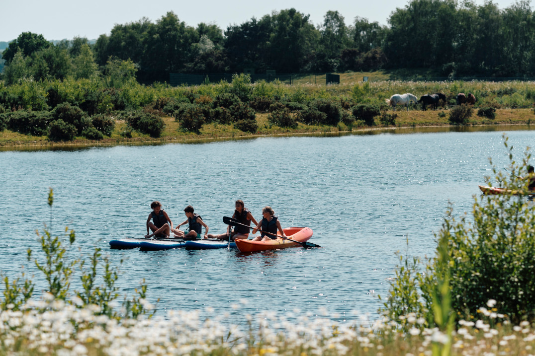 A family paddleboarding on the lake