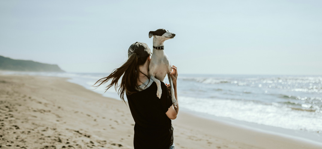 Woman with her dog on the beach